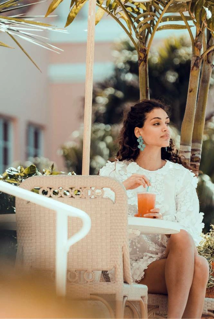 A lady having a glass of juice at Coral Gables